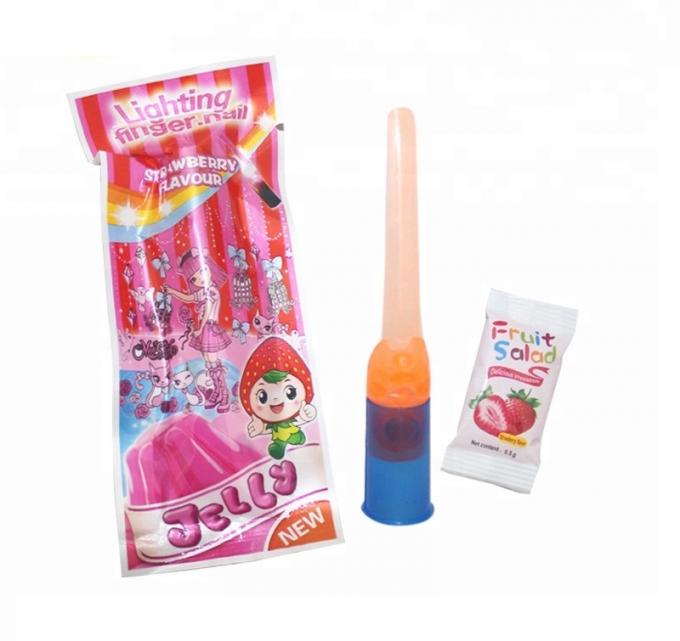 O brinquedo do prego do dedo ilumina acima doces coloridos da geleia dos doces para festas de anos